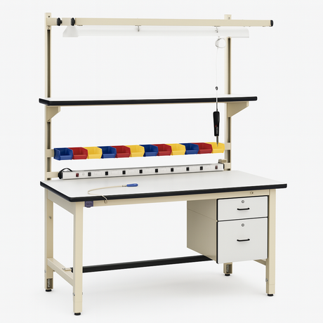 Industrial workbench with beige metal frame, white laminate surface, overhead fluorescent light, upper shelf, and colorful red, yellow, and blue storage bins. Includes built-in power strip and two-drawer side cabinet, set against a seamless white background.